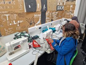 An entrepreneur making clothes on a sewing machine