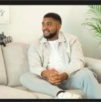 Lathan (author) photographed whilst filming a podcast (speaking into a microphone)