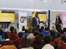 Speaker talking at a conference event with people watching